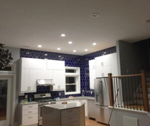 Kitchen remodel with blue tile and white cabinets